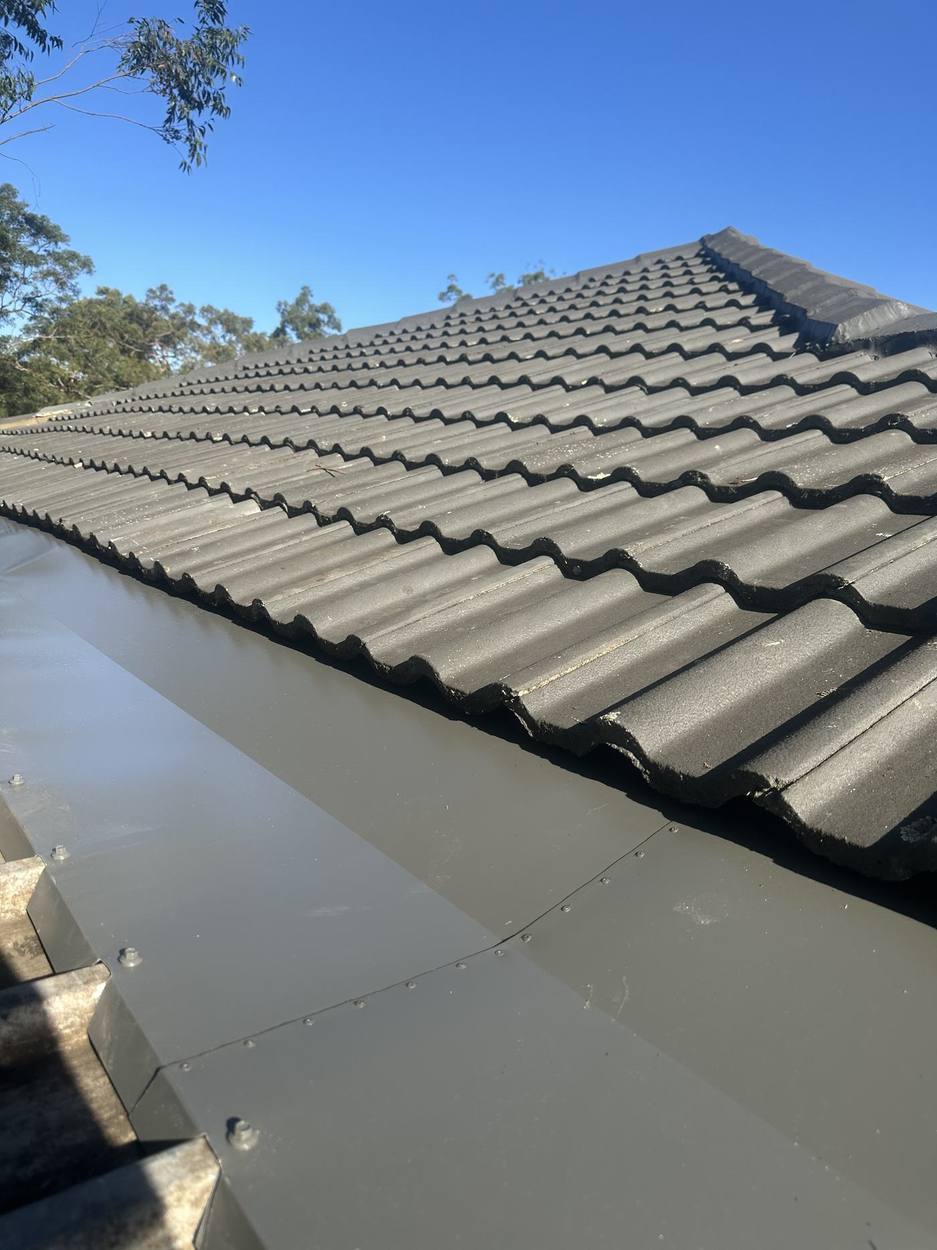 Box gutter alongside dark roof tiles