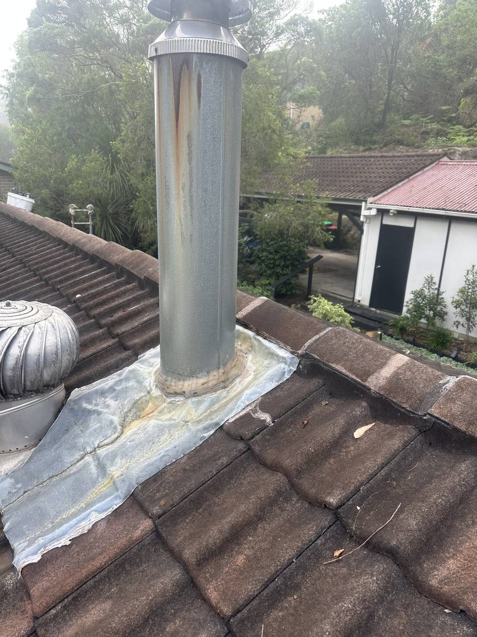 Old flue flashing patched with lead and sealant
