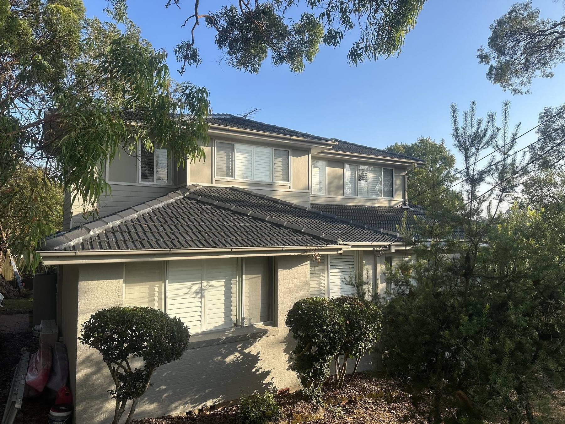 Restored charcoal tile roof on a two-storey North Shore home