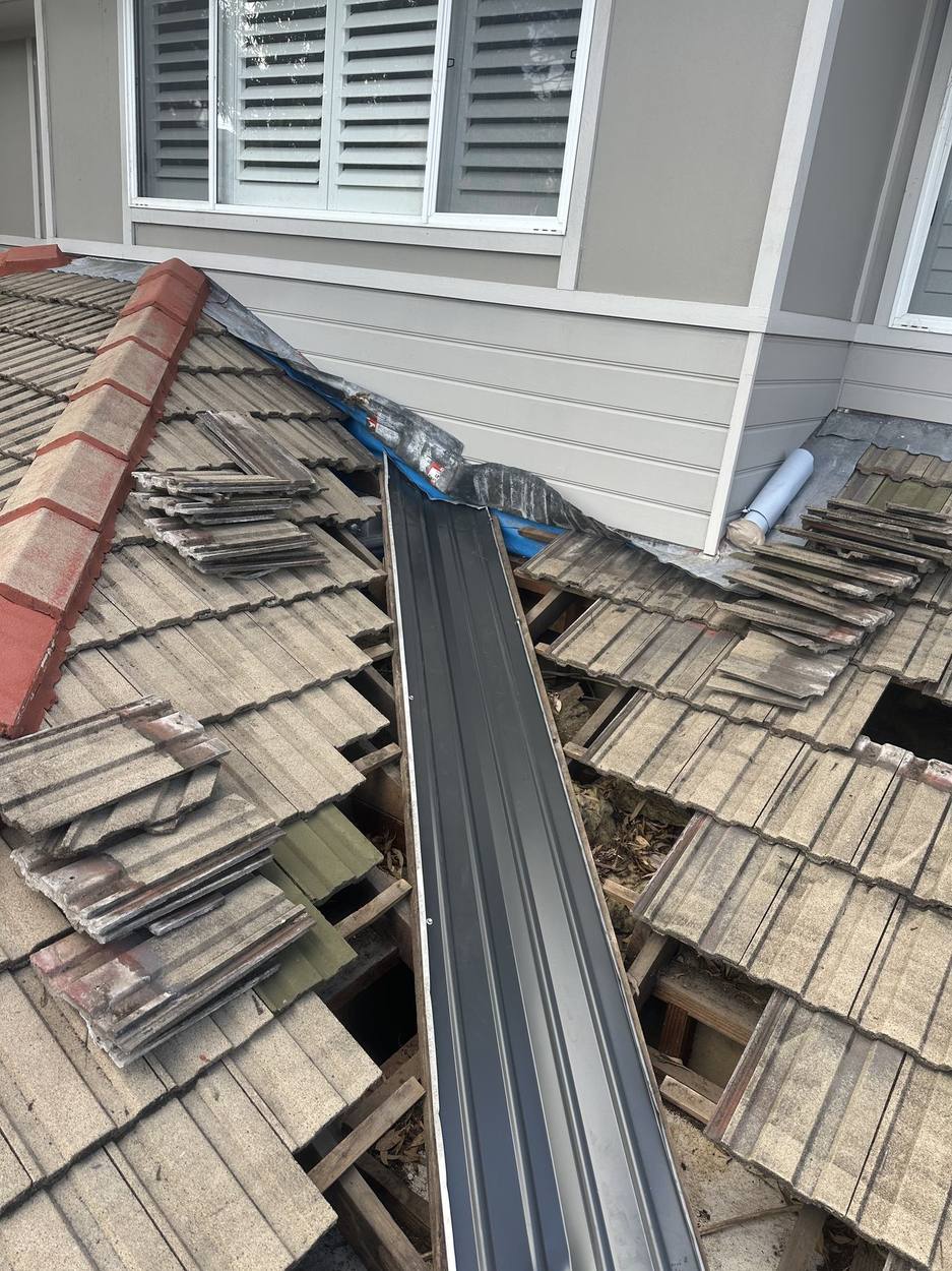 Tiles lifted and a new metal valley being installed